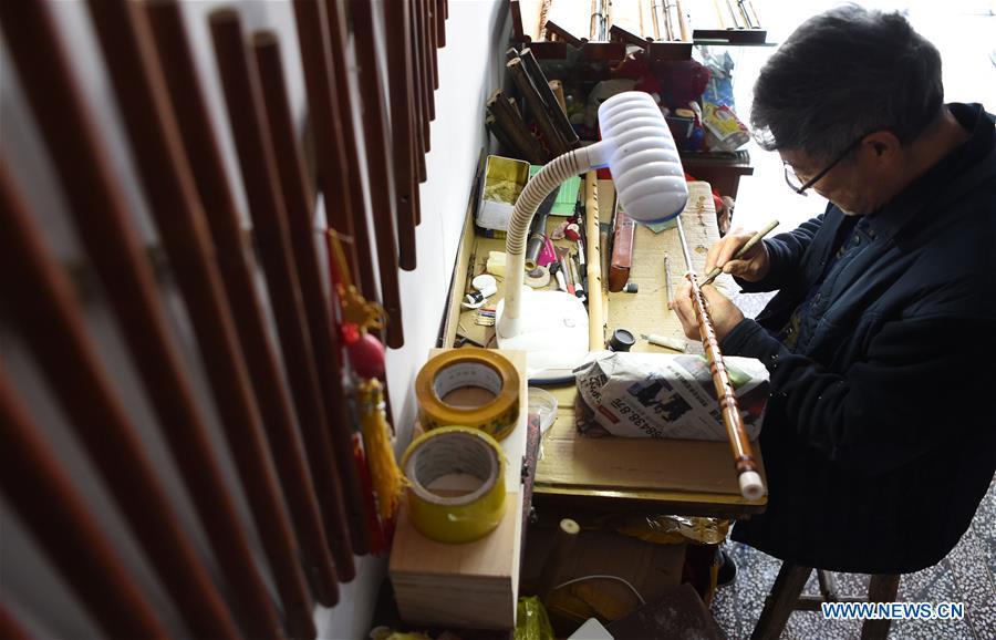 Liu Zesong, inheritor of the Yuping bamboo flute making craft, carves on a flute in Yuping Dong Autonomous County, southwest China\'s Guizhou Province, Nov. 29, 2018. As a traditional Chinese bamboo instrument, Yuping bamboo flute is famous for its clear tone and delicate carving. Made from local bamboo, the flute goes through dozens of procedures before finished and merges folk cultures of other ethnic groups. It was listed as one of the National Intangible Cultural Heritages in 2006. (Xinhua/Ma Ning)