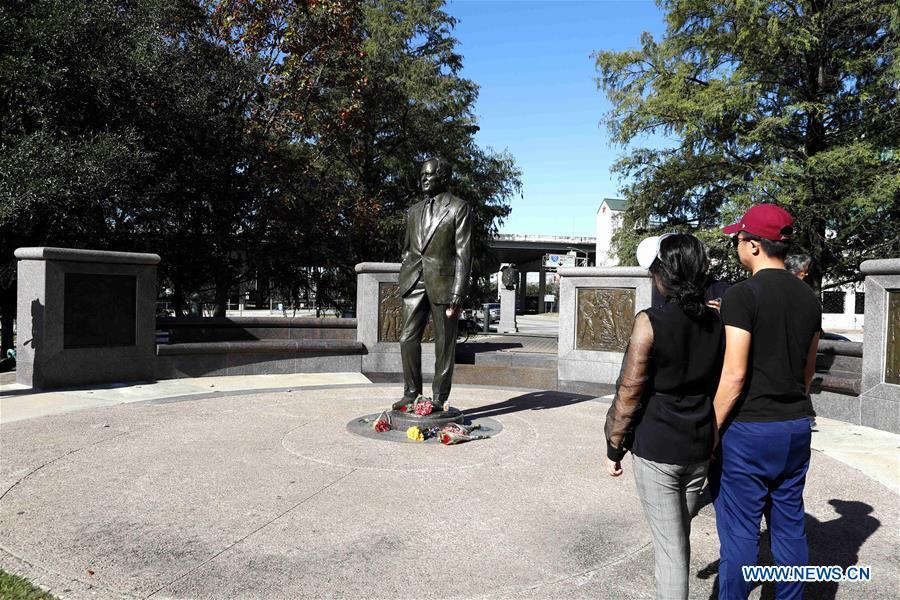 People stand in front of a statue of former U.S. President George H.W. Bush in Houston, Texas, the United States, on Dec. 1, 2018. George H.W. Bush, the 41st president of the United States, has died Friday at the age of 94, according to a statement from his office. (Xinhua/Steven Song)