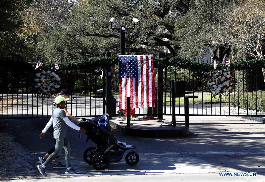 People walk past the gate of the residence of former U.S. President George H.W. Bush in Houston, Texas, the United States, on Dec. 1, 2018. George H.W. Bush, the 41st president of the United States, has died Friday at the age of 94, according to a statement from his office. (Xinhua/Steven Song)