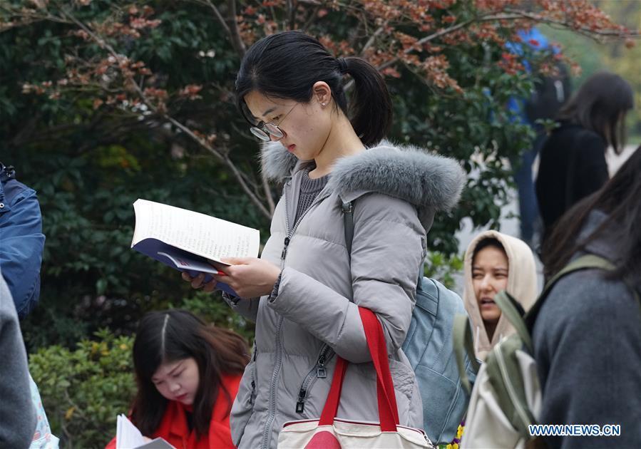 Candidates review before taking the national civil servant exam at Nanjing Forestry University in Nanjing, capital of east China\'s Jiangsu Province, Dec. 2, 2018. The written exam of the national civil servant exam was held on Sunday across the country. (Xinhua/Sun Can)