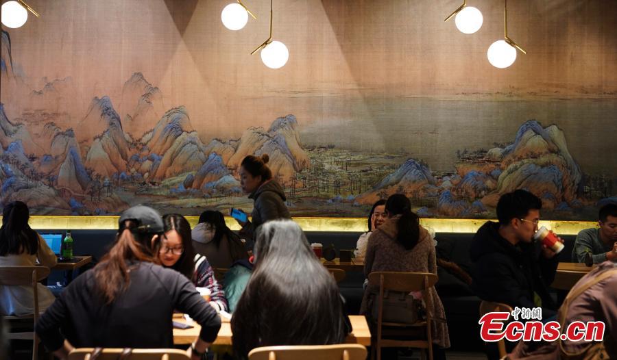 Visitors enjoy their drinks at a café newly opened outside the Palace Museum\'s Shenwu Men, or the Gate of Divine Might in Beijing on December 1, 2018. Named “Café by The Forbidden City”, the coffee shop in the theme of imperial China enables their customers to enjoy a wide range of drinks while experiencing ancient Chinese culture.  (Photo: China News Service/ Du Yang)