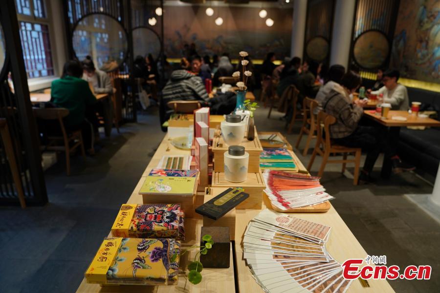 Visitors enjoy their drinks at a café newly opened outside the Palace Museum\'s Shenwu Men, or the Gate of Divine Might in Beijing on December 1, 2018. Named “Café by The Forbidden City”, the coffee shop in the theme of imperial China enables their customers to enjoy a wide range of drinks while experiencing ancient Chinese culture.  (Photo: China News Service/ Du Yang)