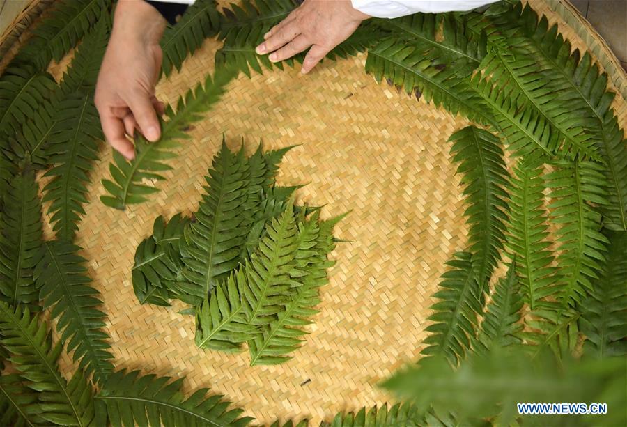 Local resident Yi Yinjie prepares to make \