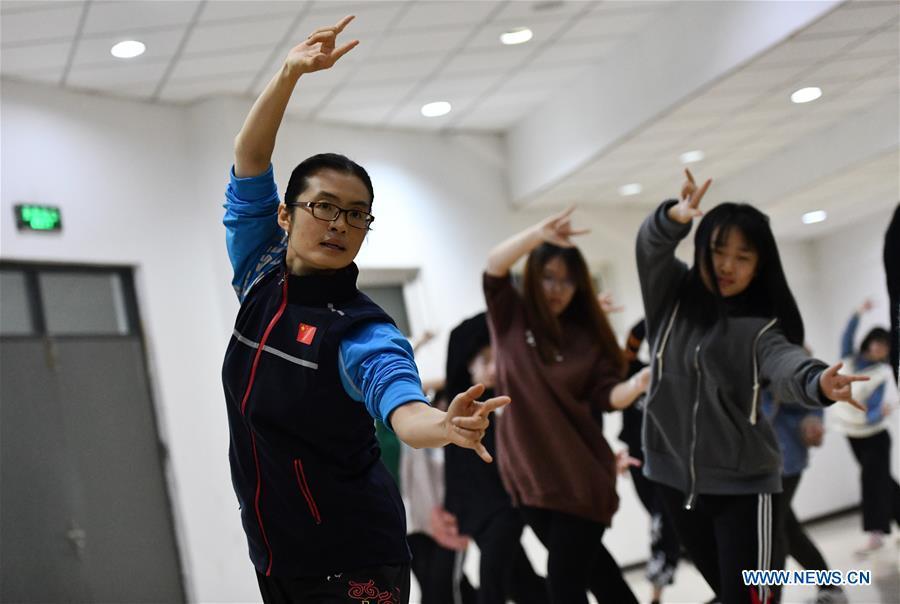Huo Jinghong, the 5th generation descendant of Huo Yuanjia, a Chinese martial arts master, teaches martial arts at Tianjin University of Commerce in Tianjin, north China, Nov. 26, 2018. As the descendant of Huo Yuanjia, one of China\'s most revered martial arts masters, Huo Jinghong, 41, started practicing martial arts at the age of 5. After her graduation from the Wushu School of Beijing Sport University in major of Wushu Routine, Huo started her career as a gym teacher of Tianjin University of Commerce in the year of 2000. As a gym teacher, Huo teaches martial arts for the university team and offers classes on health Qigong, a new form selected from different versions of traditional Qigong for modern fitness, in the university. Later in 2015, Huo became the inheritor of Huo-style boxing, which was listed as an intangible cultural heritage in Tianjin, and since then, she has devoted herself to the inheritance and development of the martial arts handed down from the older generation of Huo\'s family. She hoped that the Huo-style boxing would help people understand more about the Chinese martial arts. Huo Yuanjia was born in Tianjin in 1868. He founded the Chin Woo Athletic Association in 1910 in Shanghai and advocated the spirit of \