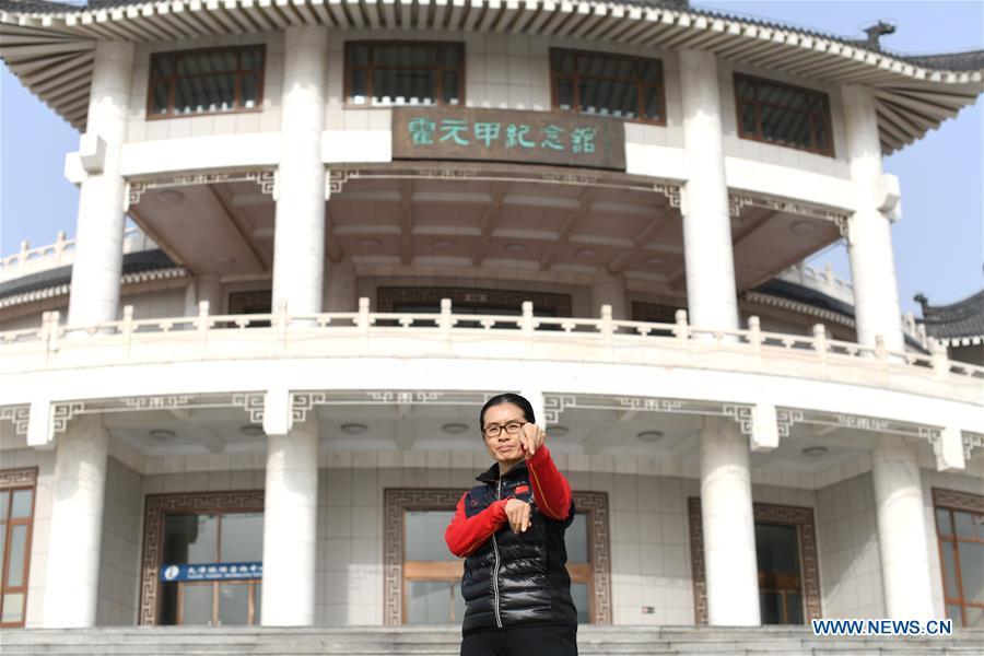 Huo Jinghong, the 5th generation descendant of Huo Yuanjia, a Chinese martial arts master, poses in front of Huo Yuanjia Memorial in Xiaonanhe Village of Jingwu Township in Tianjin, north China\'s Municipality, Nov. 28, 2018. As the descendant of Huo Yuanjia, one of China\'s most revered martial arts masters, Huo Jinghong, 41, started practicing martial arts at the age of 5. After her graduation from the Wushu School of Beijing Sport University in major of Wushu Routine, Huo started her career as a gym teacher of Tianjin University of Commerce in the year of 2000. As a gym teacher, Huo teaches martial arts for the university team and offers classes on health Qigong, a new form selected from different versions of traditional Qigong for modern fitness, in the university. Later in 2015, Huo became the inheritor of Huo-style boxing, which was listed as an intangible cultural heritage in Tianjin, and since then, she has devoted herself to the inheritance and development of the martial arts handed down from the older generation of Huo\'s family. She hoped that the Huo-style boxing would help people understand more about the Chinese martial arts. Huo Yuanjia was born in Tianjin in 1868. He founded the Chin Woo Athletic Association in 1910 in Shanghai and advocated the spirit of \