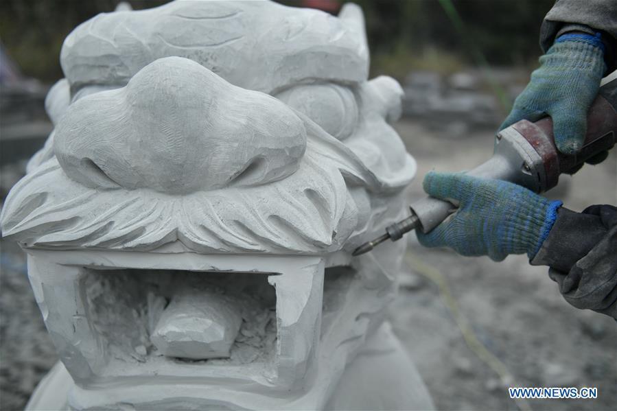 A handicraftsman processes a rock carving work in Longdong Village of Xuan\'en County in Enshi Tujia and Miao Autonomous Prefecture, central China\'s Hubei Province, Dec. 5, 2018. Residents here benefit from the rich rock resources and turn plain rocks into delicate artworks. (Xinhua/Song Wen)