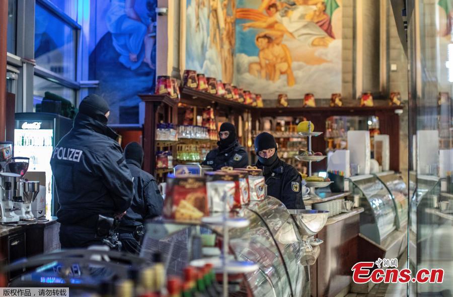 Masked police stand in an ice parlor in Duisburg, western Germany, Wednesday, Dec. 5, 2018 as authorities conduct coordinated raids in Germany, Italy, Belgium and the Netherlands in a crackdown on the Italian mafia. German federal police said in a statement Wednesday that there had been multiple arrests in the early morning raids on premises linked to the \'ndrangheta, a southern Italy-based organized crime group.  (Photo/Agencies)