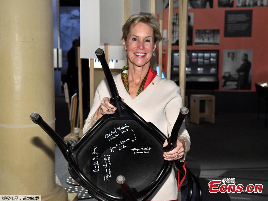 The Nobel Prize laureate in chemistry Frances H. Arnold holds a chair she has signed at the Nobel Museum in Stockholm, Sweden on December 6, 2018. (Photo/Agencies)