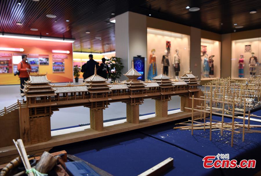 Visitors look at a model of Fengyu Bridge, or Wind and Rain Bridge because the pavilions built on the bridge provide shelter to people from the wind and rain, at an exhibition to mark the 60th anniversary of the establishment of the Guangxi Zhuang Autonomous Region in the region’s capital Nanning City, Dec. 10, 2018. Established in 1958 as an autonomous region, Guangxi has a population of 56 million, including more than 20 million who identify as ethnic minorities. It tops in China’s provincial-level regions in minority populations. (Photo: China News Service/Hou Yu)