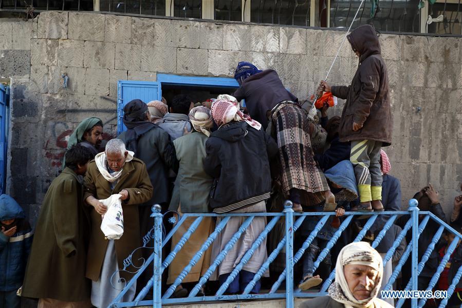 Yemeni people gather at a charity center to receive food aid in Sanaa, Yemen, on Dec. 9, 2018. An estimated 85,000 children under the age of five may have died from extreme hunger between April 2015 and October 2018, according to the latest data released by Save the Children, an international organization for children\'s rights. (Xinhua/Mohammed Mohammed)