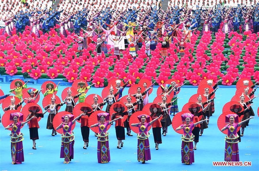 Dancers perform in a grand gathering held to celebrate the 60th anniversary of the founding of south China\'s Guangxi Zhuang Autonomous Region in Nanning, capital of Guangxi, Dec. 10, 2018. (Xinhua/Zhou Hua)