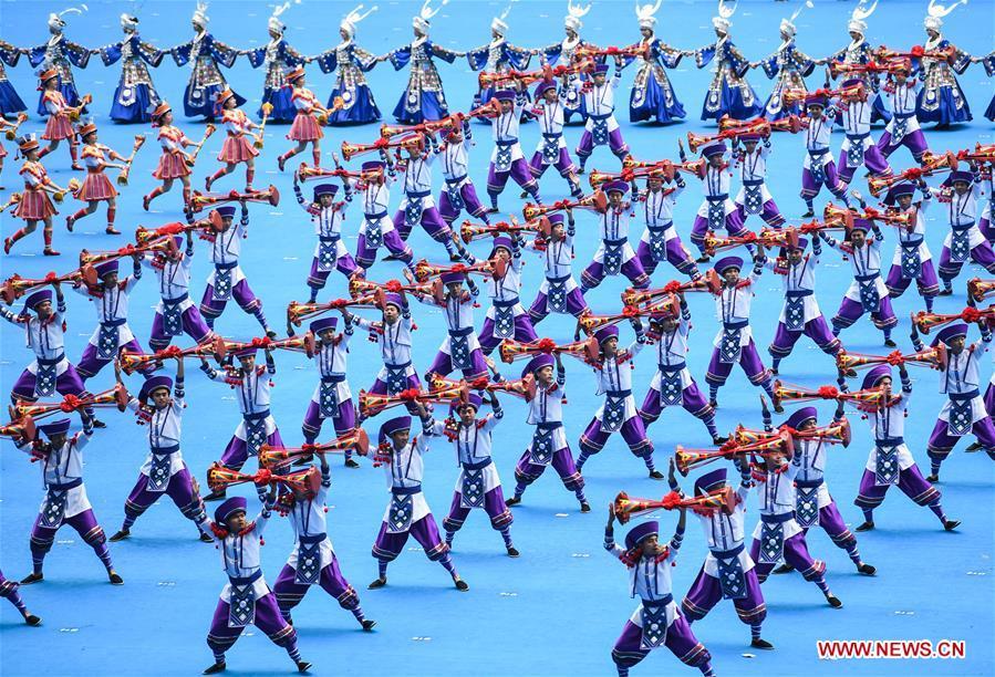 Dancers perform in a grand gathering held to celebrate the 60th anniversary of the founding of south China\'s Guangxi Zhuang Autonomous Region in Nanning, capital of Guangxi, Dec. 10, 2018. (Xinhua/Shen Hong)