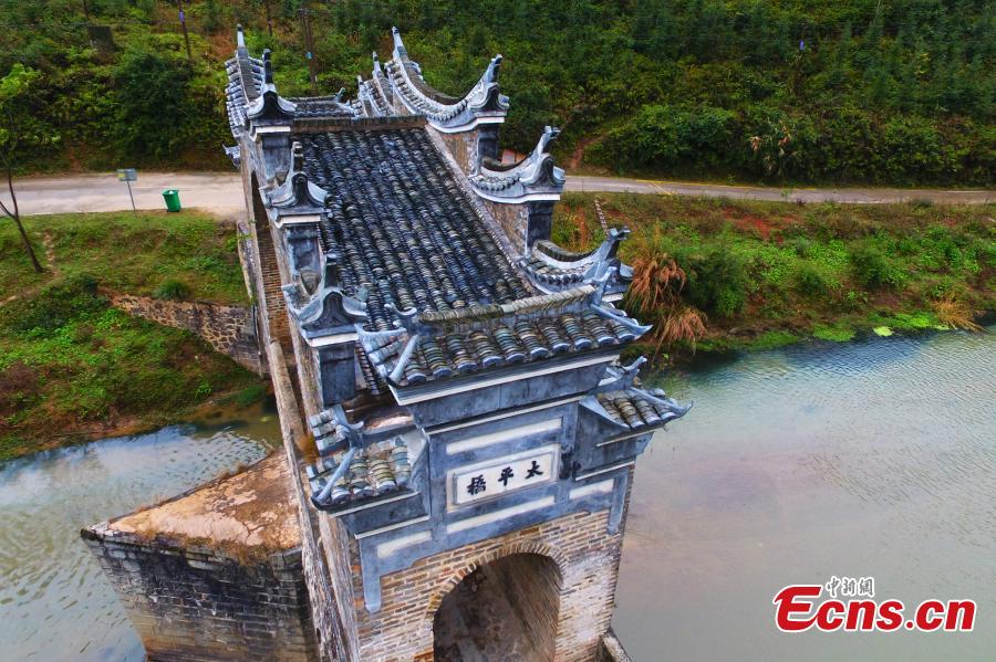 An aerial view of Taiping Bridge (Peace Bridge) in Longnan County, Jiangxi Province, Dec. 9, 2018. The double-layered stone bridge has two archways at the bottom and one on the top, a rare design. Built during the Ming Dynasty (1368-1644), the 50-meter-long bridge is now a cultural relic under national protection. (Photo: China News Service/Liu Zhankun)