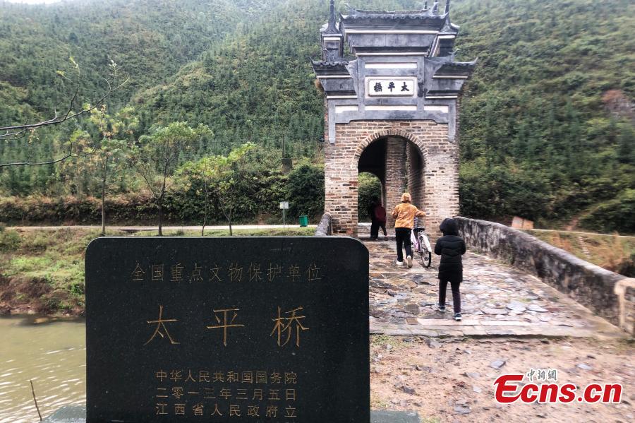 An aerial view of Taiping Bridge (Peace Bridge) in Longnan County, Jiangxi Province, Dec. 9, 2018. The double-layered stone bridge has two archways at the bottom and one on the top, a rare design. Built during the Ming Dynasty (1368-1644), the 50-meter-long bridge is now a cultural relic under national protection. (Photo: China News Service/Liu Zhankun)