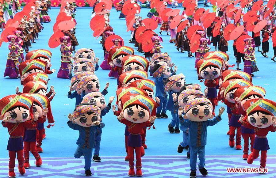 Dancers perform in a grand gathering held to celebrate the 60th anniversary of the founding of south China\'s Guangxi Zhuang Autonomous Region in Nanning, capital of Guangxi, Dec. 10, 2018. (Xinhua/Zhou Hua)