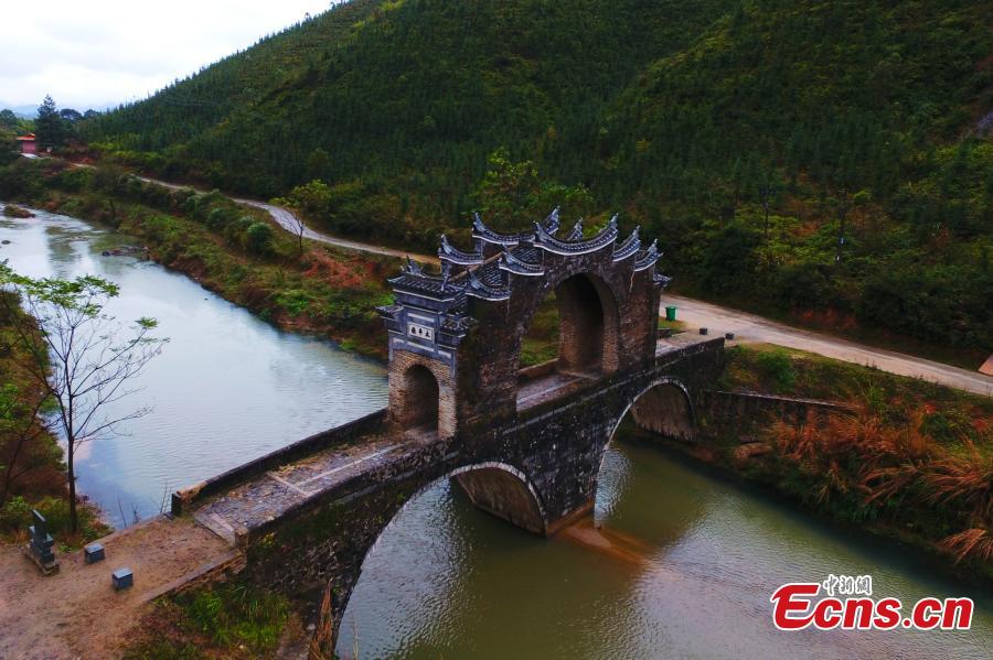 An aerial view of Taiping Bridge (Peace Bridge) in Longnan County, Jiangxi Province, Dec. 9, 2018. The double-layered stone bridge has two archways at the bottom and one on the top, a rare design. Built during the Ming Dynasty (1368-1644), the 50-meter-long bridge is now a cultural relic under national protection. (Photo: China News Service/Liu Zhankun)