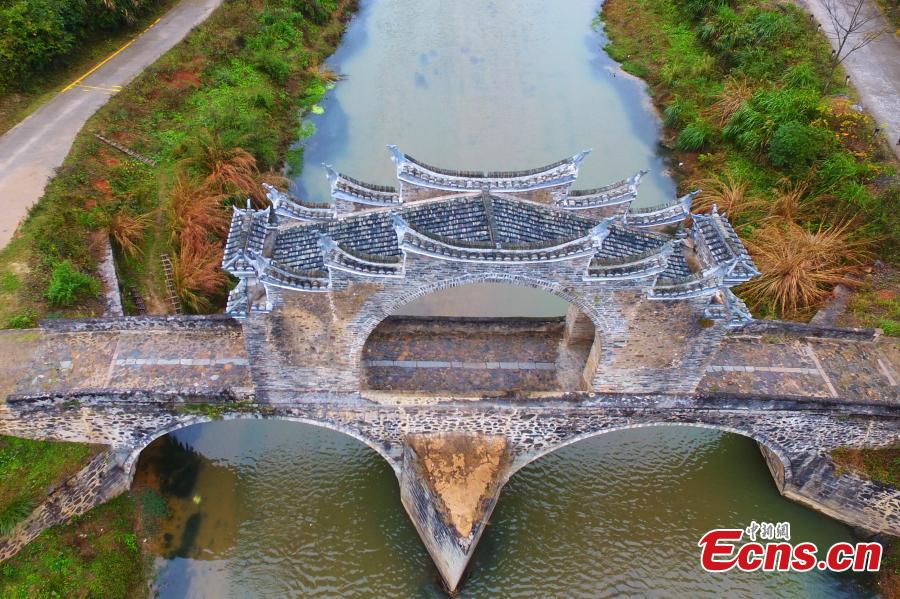 An aerial view of Taiping Bridge (Peace Bridge) in Longnan County, Jiangxi Province, Dec. 9, 2018. The double-layered stone bridge has two archways at the bottom and one on the top, a rare design. Built during the Ming Dynasty (1368-1644), the 50-meter-long bridge is now a cultural relic under national protection. (Photo: China News Service/Liu Zhankun)