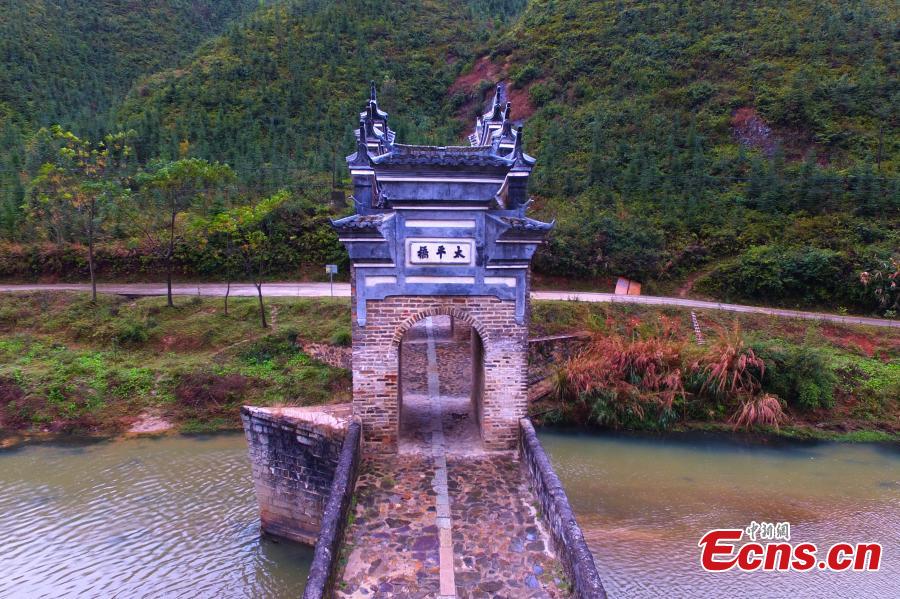 An aerial view of Taiping Bridge (Peace Bridge) in Longnan County, Jiangxi Province, Dec. 9, 2018. The double-layered stone bridge has two archways at the bottom and one on the top, a rare design. Built during the Ming Dynasty (1368-1644), the 50-meter-long bridge is now a cultural relic under national protection. (Photo: China News Service/Liu Zhankun)