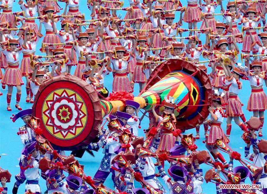 Dancers perform in a grand gathering held to celebrate the 60th anniversary of the founding of south China\'s Guangxi Zhuang Autonomous Region in Nanning, capital of Guangxi, Dec. 10, 2018. (Xinhua/Chen Jianli)