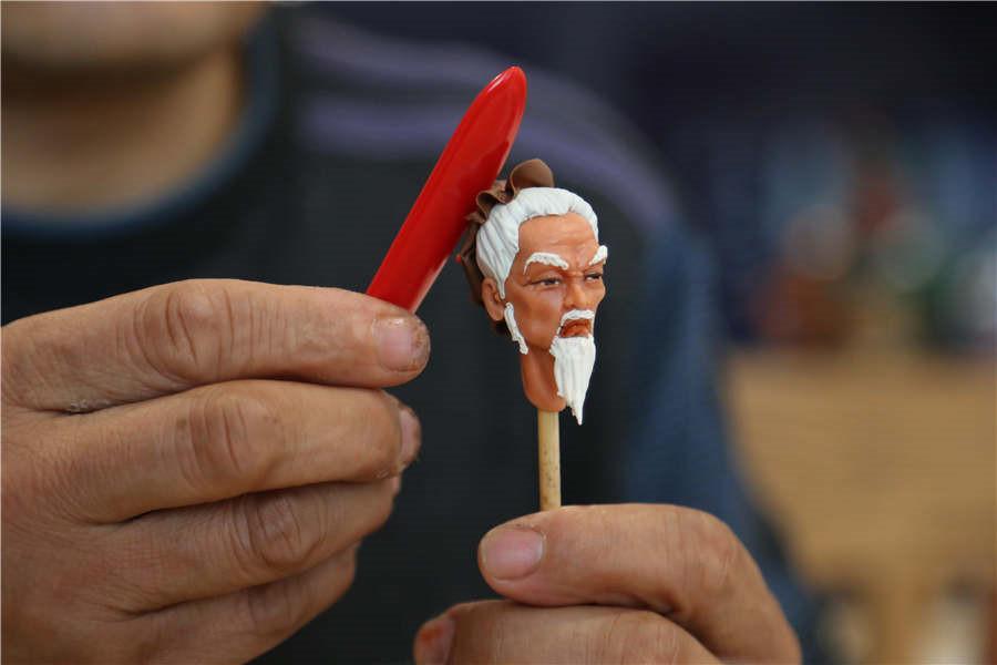 A vivid character from a Chinese legend is made by Gao in minutes.  (Photo by Li Hao/for chinadaily.com.cn)