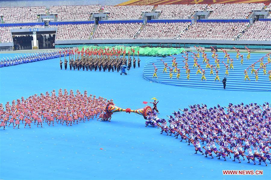 Dancers perform in a grand gathering held to celebrate the 60th anniversary of the founding of south China\'s Guangxi Zhuang Autonomous Region in Nanning, capital of Guangxi, Dec. 10, 2018. (Xinhua/Li Xin)