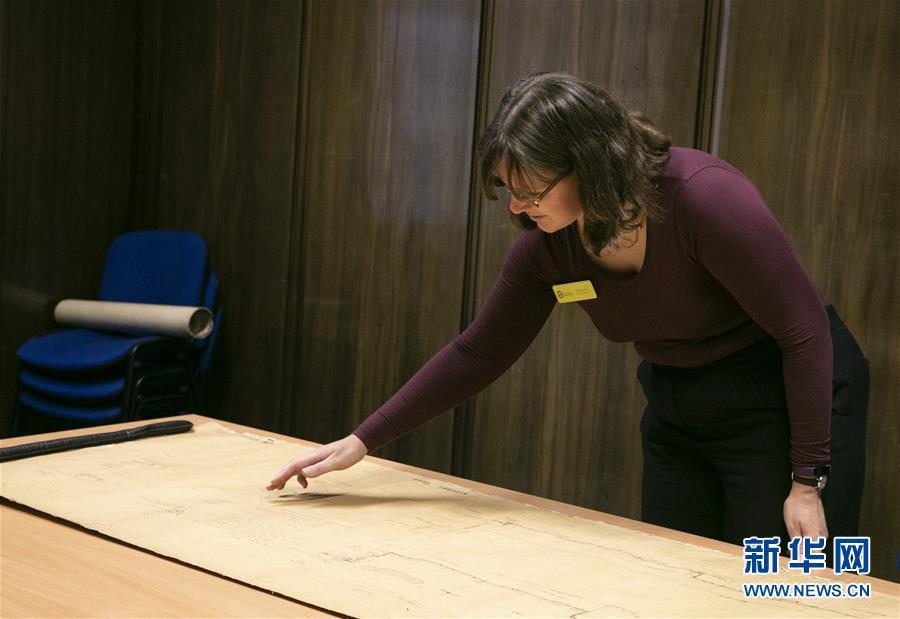 Archivist Rachel Gill shows the original designs for Chinese cruiser Zhiyuan at Tyne & Wear Archives in the city of Newcastle upon Tyne, England, Nov. 2, 2018. Zhiyuan, built and completed in England in 1887, was one of the most advanced warships in the Beiyang Fleet. It sank after the imperial Chinese navy was defeated in 1894 by the Japanese navy in the Battle of the Yellow Sea. The museum has a set of seven design drawings related to the Chinese cruiser. (Photo/Xinhua)