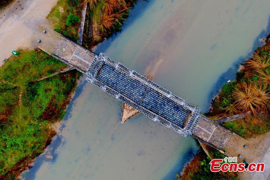 An aerial view of Taiping Bridge (Peace Bridge) in Longnan County, Jiangxi Province, Dec. 9, 2018. The double-layered stone bridge has two archways at the bottom and one on the top, a rare design. Built during the Ming Dynasty (1368-1644), the 50-meter-long bridge is now a cultural relic under national protection. (Photo: China News Service/Liu Zhankun)