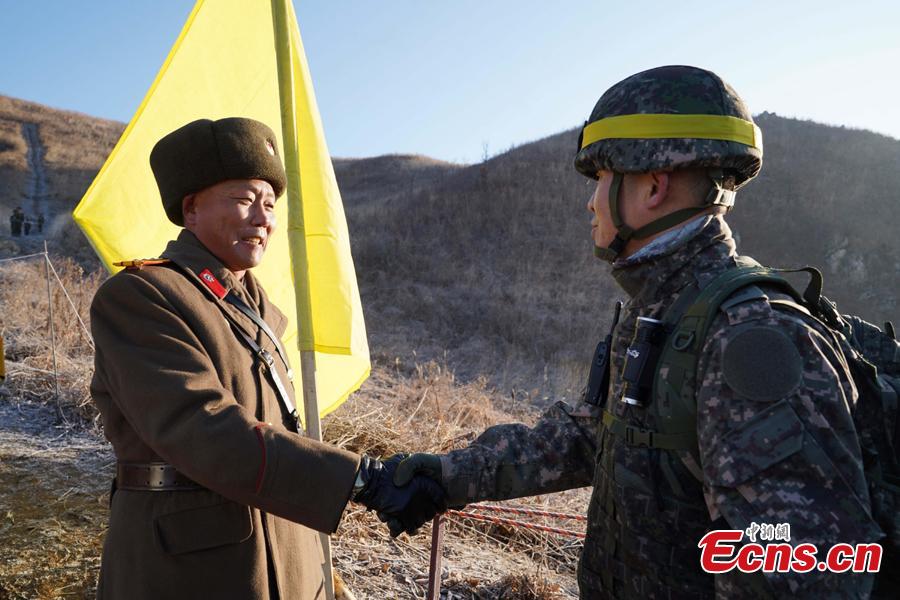 In this photo provided by South Korea Defense Ministry, South Korean army Col. Yun Myung-shick (right) shakes hands with North Korean army Lt. Col. Ri Jong Su before crossing the Military Demarcation Line inside the Demilitarized Zone (DMZ) to inspect the dismantled North Korean guard post in the central section of the inter-Korean border in Cheorwon, Dec. 12, 2018. Dozens of soldiers from two countries crossed over the world\'s most heavily armed border Wednesday as they inspected the sites of their rival\'s front-line guard posts to verify they\'d been removed. (Photo provided by South Korea Defense Ministry)