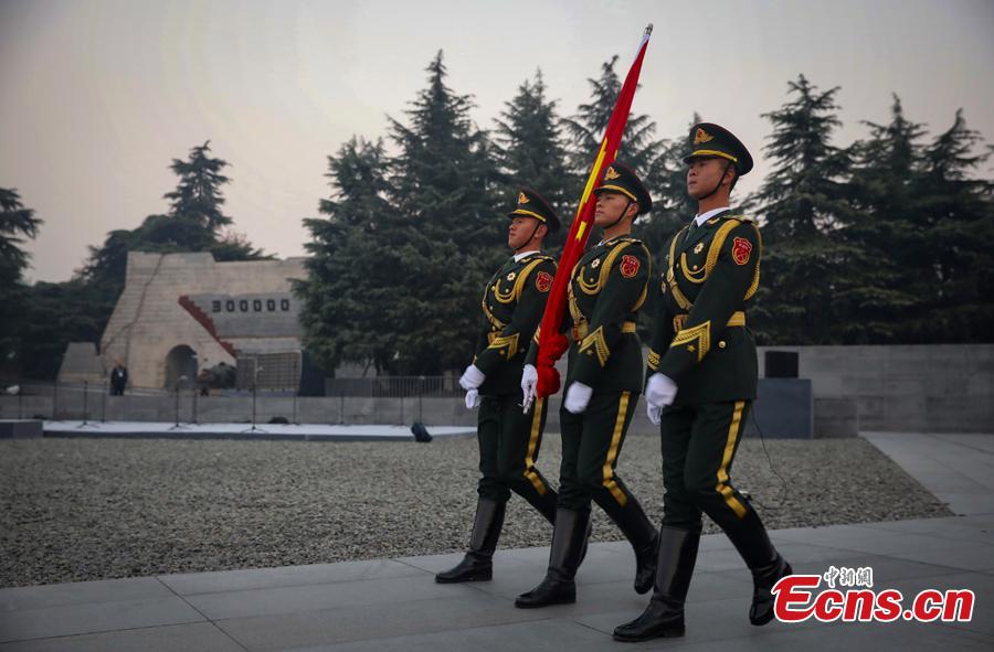 Photo taken on Dec. 13, 2018 shows the scene of the National Memorial Day for Nanjing Massacre Victims at the Memorial Hall of the Victims in Nanjing Massacre by Japanese Invaders in Nanjing City, Jiangsu Province. On Thursday, China marked the fifth national memorial day to commemorate the victims of the Nanjing Massacre, in which Japanese invaders slaughtered about 300,000 Chinese during a six-week rampage after they captured the city, then China\'s capital, in 1937. In front of the darkly-dressed crowd at the ceremony, China\'s national flag is flown at half-mast. In February 2014, China\'s top legislature designated December 13 as the National Memorial Day for Nanjing Massacre Victims. (Photo: China News Service/Yang Bo)