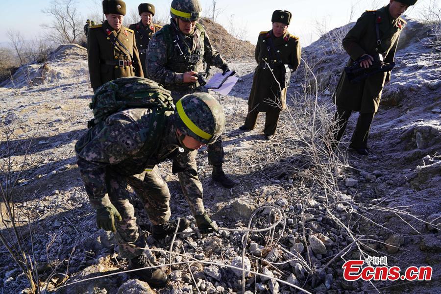 In this photo provided by South Korea Defense Ministry, South Korean army soldiers, wearing helmets, inspect at the dismantled North Korean guard post inside the Demilitarized Zone (DMZ) in the central section of the inter-Korean border in Cheorwon, Dec. 12, 2018. Dozens of soldiers from two countries crossed over the world\'s most heavily armed border Wednesday as they inspected the sites of their rival\'s front-line guard posts to verify they\'d been removed. (Photo provided by South Korea Defense Ministry)