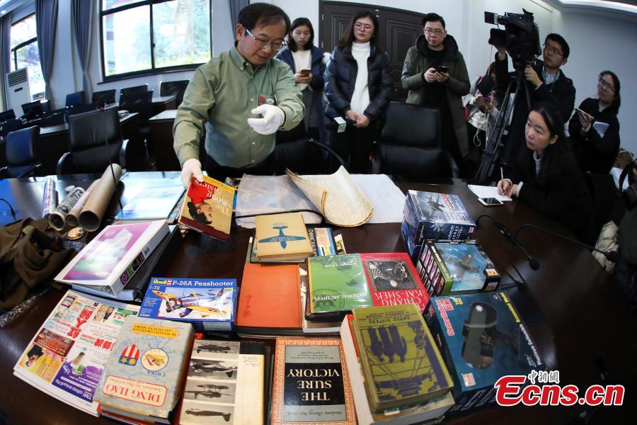 Chinese-American Lu Zhaoning donates historical materials to the Memorial Hall of the Aviator Martyrs in the War of Resistance against Japanese Aggression in Nanjing City, Jiangsu Province, Dec. 14, 2018. The relics included pilot’s suits, books by Flying Tiger pilots and other materials about WWII war planes. Lu’s relative Lu Meiyin served as a flight attendant in the war. The memorial hall shows the names and a basic introduction in Chinese, English and Russian on thousands of pilots from China, the United States and Soviet Union who died in China during the war. (Photo: China News Service/Yang Bo)