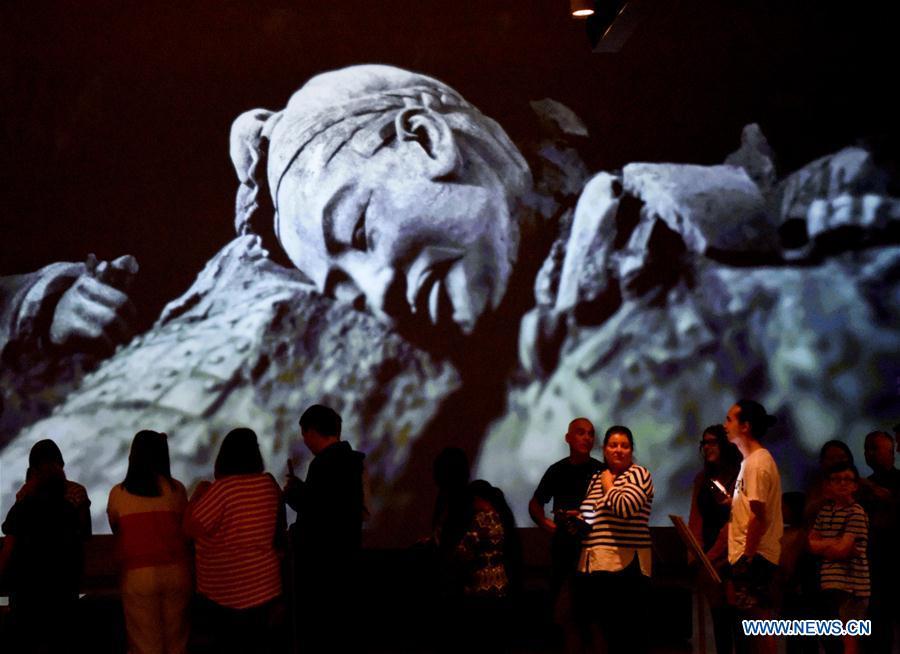 Visitors wait for entering the exhibition Terracotta Warriors: Guardians of Immortality at the National Museum of New Zealand in Wellington, New Zealand, on Dec. 15, 2018. The landmark exhibition of Terracotta Warriors: Guardians of Immortality opened to public on Saturday at the National Museum of New Zealand. The exhibition features eight warriors standing 180 cm tall, and two full-size horses from the famous terracotta army, as well as two half-size replica bronze horse-drawn chariots. Also on display are more than 160 exquisite works of ancient Chinese art made from gold, jade and bronze. \