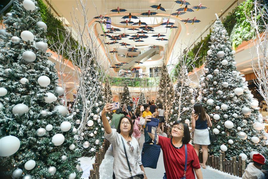 People pose for photos with Christmas decorations at a shopping mall in Kuala Lumpur, Malaysia, on Dec. 16, 2018. (Xinhua/Chong Voon Chung)