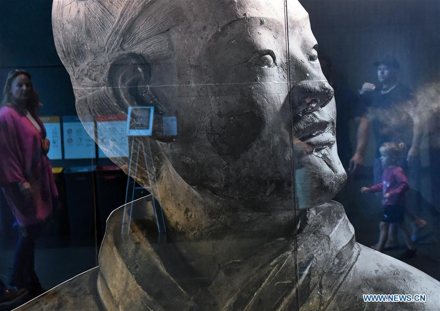Visitors view the exhibits during the exhibition Terracotta Warriors: Guardians of Immortality at the National Museum of New Zealand in Wellington, New Zealand, on Dec. 15, 2018. The landmark exhibition of Terracotta Warriors: Guardians of Immortality opened to public on Saturday at the National Museum of New Zealand. The exhibition features eight warriors standing 180 cm tall, and two full-size horses from the famous terracotta army, as well as two half-size replica bronze horse-drawn chariots. Also on display are more than 160 exquisite works of ancient Chinese art made from gold, jade and bronze. \