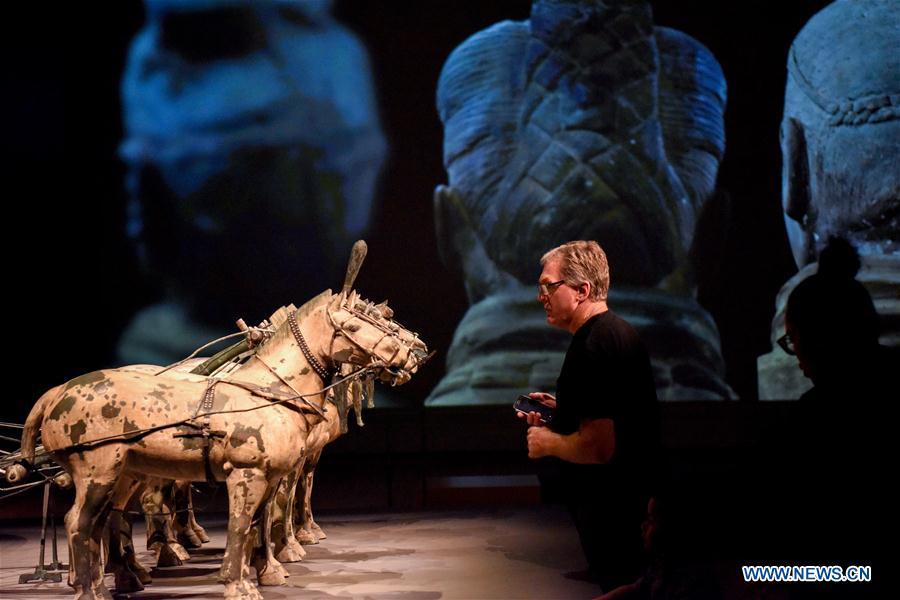 A visitor views the exhibits during the exhibition Terracotta Warriors: Guardians of Immortality at the National Museum of New Zealand in Wellington, New Zealand, on Dec. 15, 2018. The landmark exhibition of Terracotta Warriors: Guardians of Immortality opened to public on Saturday at the National Museum of New Zealand. The exhibition features eight warriors standing 180 cm tall, and two full-size horses from the famous terracotta army, as well as two half-size replica bronze horse-drawn chariots. Also on display are more than 160 exquisite works of ancient Chinese art made from gold, jade and bronze. \