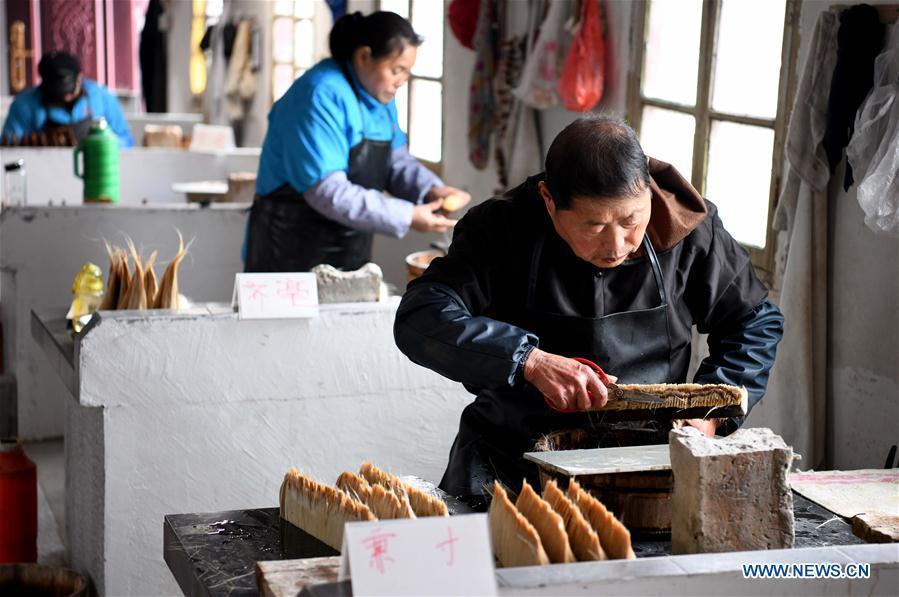 Workers make the Xuan ink brushes at a workshop in Huangcun Town of Jingxian County, east China\'s Anhui Province, Dec. 14, 2018. Huangcun Town has a long history of the Xuan ink brush making. The ink brush, ink, Chinese Xuan paper and ink slabs are four traditional writing materials of Chinese stationery. (Xinhua/Liu Junxi)