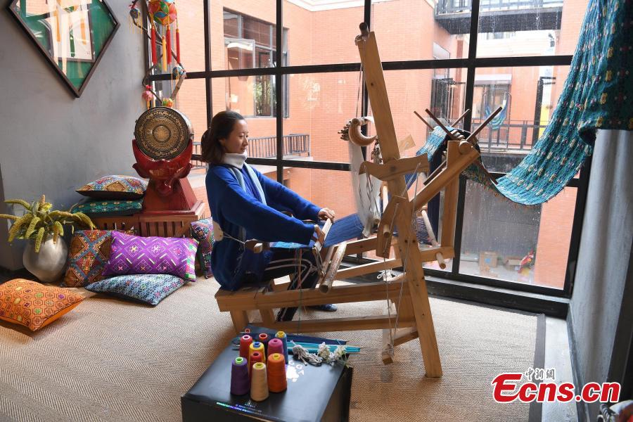 A store features products that integrate the intangible cultural heritages of the Zhuang people in Nanning City, Southwest China\'s Guangxi Zhuang Autonomous Region, Dec. 17, 2018. The products, including leatherware, clothes and bags, highlight the unique crafts of the Zhuang people. (Photo: China News Service/Yu Jing)