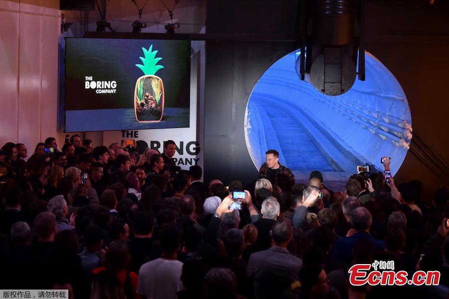 Elon Musk, co-founder and chief executive officer of Tesla Inc., walks into the crowd during an unveiling event for the Boring Company Hawthorne test tunnel in Hawthorne, California, U.S., Dec. 18, 2018. Musk unveiled his underground transportation tunnel on Tuesday, allowing reporters and invited guests to take some of the first rides in the revolutionary albeit bumpy subterranean tube — the tech entrepreneur\'s answer to what he calls \