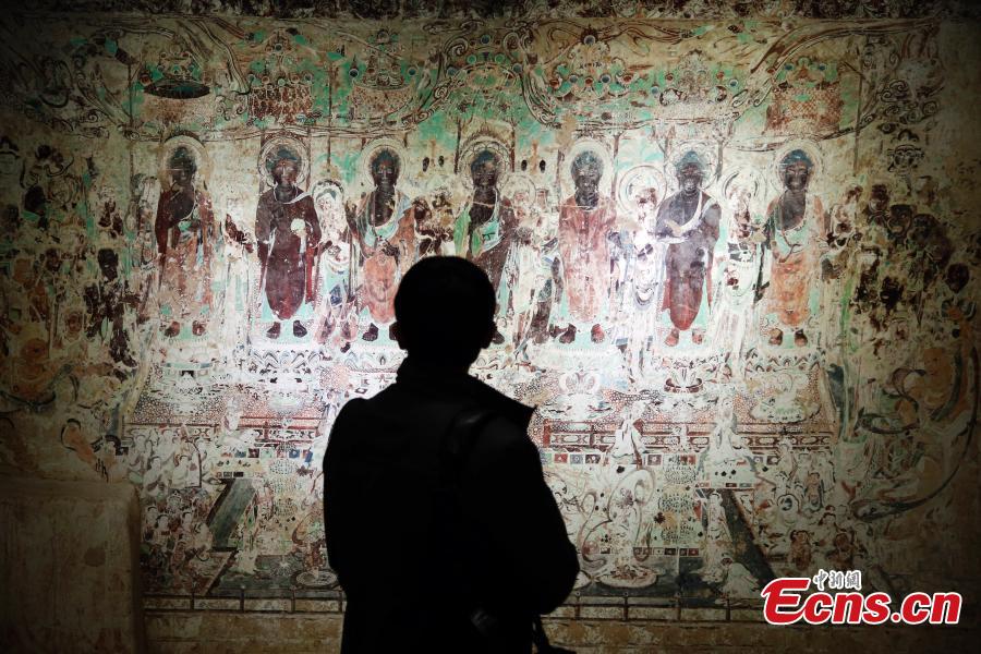 An exhibition of Dunhuang art masterpieces in Shanghai, Dec. 20, 2018. The non-profit exhibition tour at universities brought 66 large-size digital high-definition murals from the Mogao Caves. (Photo: China News Service/Tang Yanjun)