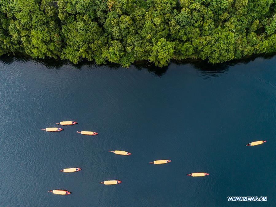 Sightseeing boats are seen on Xin\'an River Jiande section in east China\'s Zhejiang Province, July 23, 2018. Colors make our world bright and beautiful. In 2018, Xinhua photographers across China explored views from the sky with drones. Here are these drone photos with amazing colors. (Xinhua/Xu Yu)