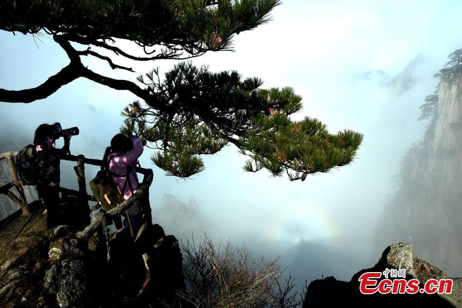 Mist and clouds surround Mount Huangshan in Anhui Province on Dec. 20, 2018. A UNESCO World Heritage site, the area is well known for its scenery, sunsets, peculiarly-shaped granite peaks, and pine trees. (Photo: China News Service/Wang Hui)