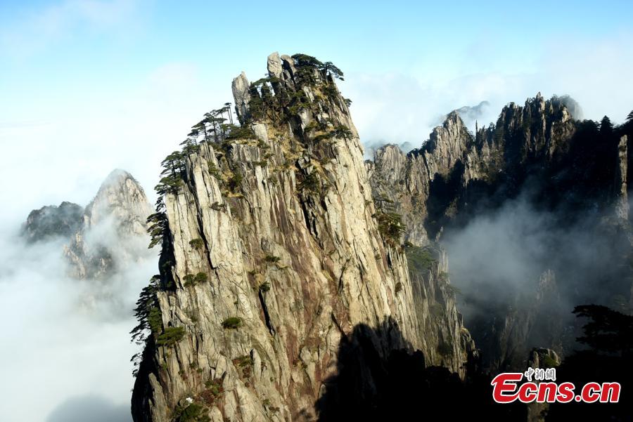 Mist and clouds surround Mount Huangshan in Anhui Province on Dec. 20, 2018. A UNESCO World Heritage site, the area is well known for its scenery, sunsets, peculiarly-shaped granite peaks, and pine trees. (Photo: China News Service/Wang Hui)