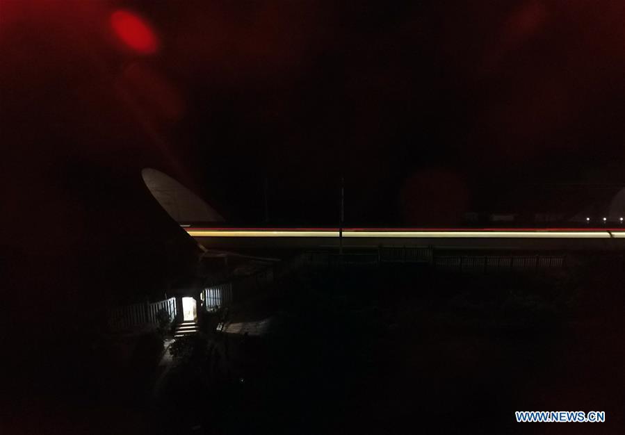 A high speed train enters the Tanzhu Tunnel at night in Nanning, south China\'s Guangxi Zhuang Autonomous Region, Feb. 11, 2018. The living and working scenes of Chinese people in the past year have created a series of amazing views, some of which formed geometric figures. Those photos tell the development and progress of the country in 2018. (Xinhua/Lu Boan)
