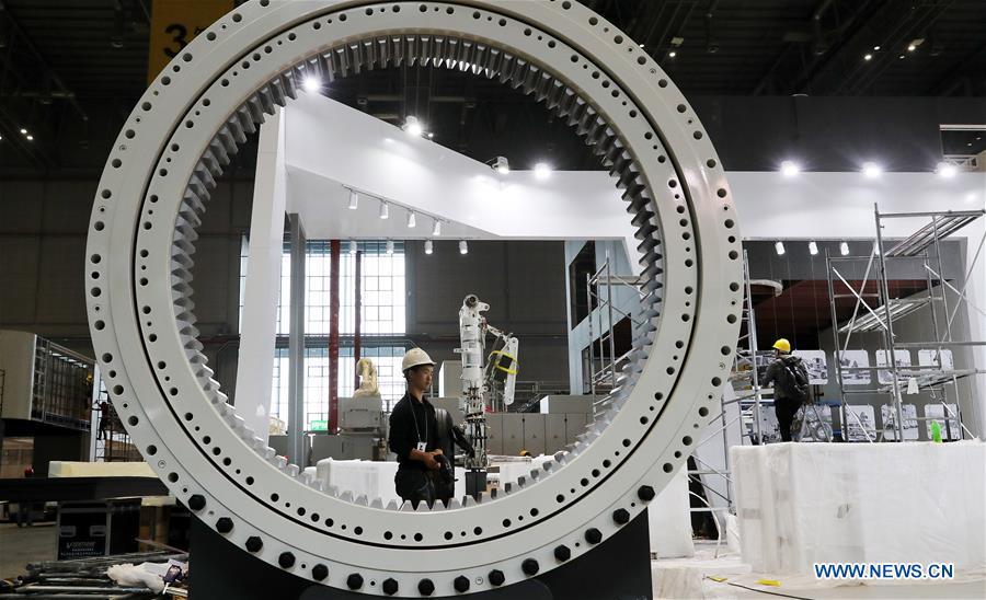 Workers install exhibits at an exhibition hall in the National Exhibition and Convention Center (Shanghai) in Shanghai, east China, on Oct. 30, 2018. The living and working scenes of Chinese people in the past year have created a series of amazing views, some of which formed geometric figures. Those photos tell the development and progress of the country in 2018. (Xinhua/Fang Zhe)