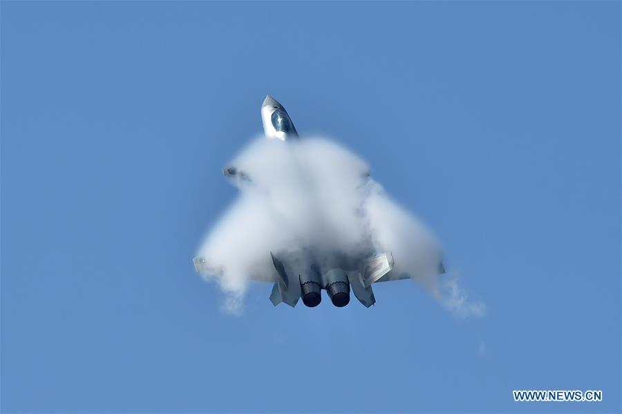 A J-20 fighter jet performs an aerobatics display during the 12th China International Aviation and Aerospace Exhibition (Airshow China) in Zhuhai, south China\'s Guangdong Province, on Nov. 6, 2018. The living and working scenes of Chinese people in the past year have created a series of amazing views, some of which formed geometric figures. Those photos tell the development and progress of the country in 2018. (Xinhua/Liang Xu)
