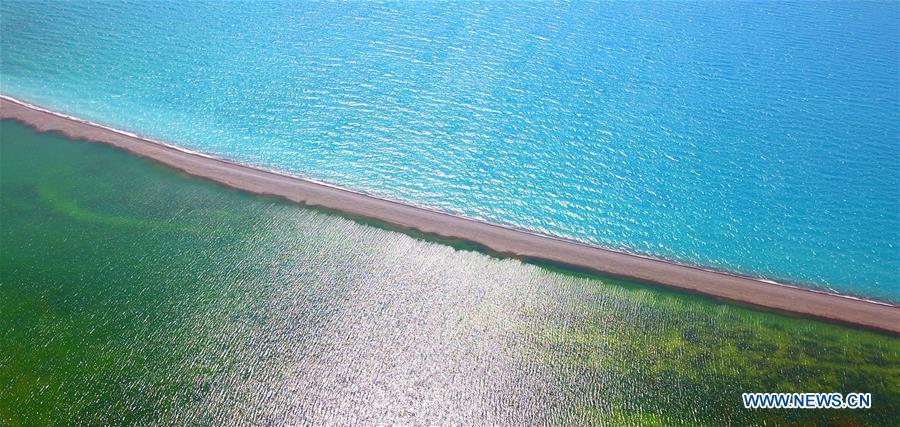 Aerial photo taken on July 18, 2018 shows the scenery of the Sayram Lake in northwest China\'s Xinjiang Uygur Autonomous Region. The living and working scenes of Chinese people in the past year have created a series of amazing views, some of which formed geometric figures. Those photos tell the development and progress of the country in 2018. (Xinhua/Xu Congjun)