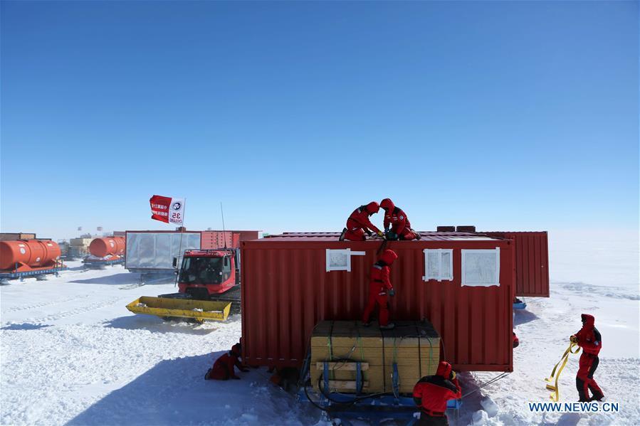 Members of two inland expedition teams maintain the equipment after a blizzard in Antarctica, Dec. 21, 2018. Two teams of Chinese researchers on China\'s 35th Antarctic expedition encountered a blizzard on their way to China\'s Kunlun and Taishan stations on Friday. (Xinhua/Liu Shiping)