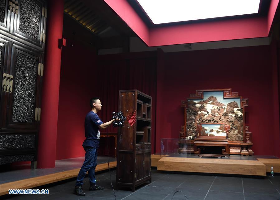 A staff worker measures and models a piece of old furniture by special instrument at an exhibition hall at the foot of southern rampart at the Palace Museum in Beijing, capital of China, July 6, 2018. The Palace Museum, or the former imperial palace in downtown Beijing, will open 85 percent of its areas to the public, compared with the current 80 percent, the China Daily reported Friday. Most of the areas inside the museum, also known as the Forbidden City, will no longer be off-limits for the public, the newspaper quoted Shan Jixiang, the museum\'s curator, as saying. The biggest of its kind in the world, the Forbidden City is gradually opening more of its coverage of 720,000 square meters to visitors in recent years. Only 30 percent of its areas were accessible by the public in 2012. Some rooms that had not been opened for decades were used as \