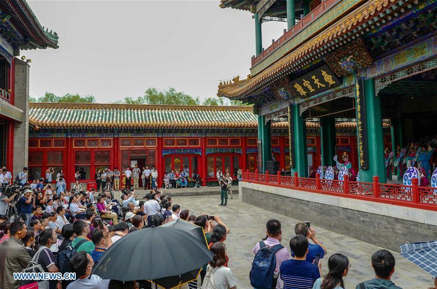 Tourists enjoy traditional opera at the Palace Museum in Beijing, capital of China, June 9, 2018. The Palace Museum, or the former imperial palace in downtown Beijing, will open 85 percent of its areas to the public, compared with the current 80 percent, the China Daily reported Friday. Most of the areas inside the museum, also known as the Forbidden City, will no longer be off-limits for the public, the newspaper quoted Shan Jixiang, the museum\'s curator, as saying. The biggest of its kind in the world, the Forbidden City is gradually opening more of its coverage of 720,000 square meters to visitors in recent years. Only 30 percent of its areas were accessible by the public in 2012. Some rooms that had not been opened for decades were used as \