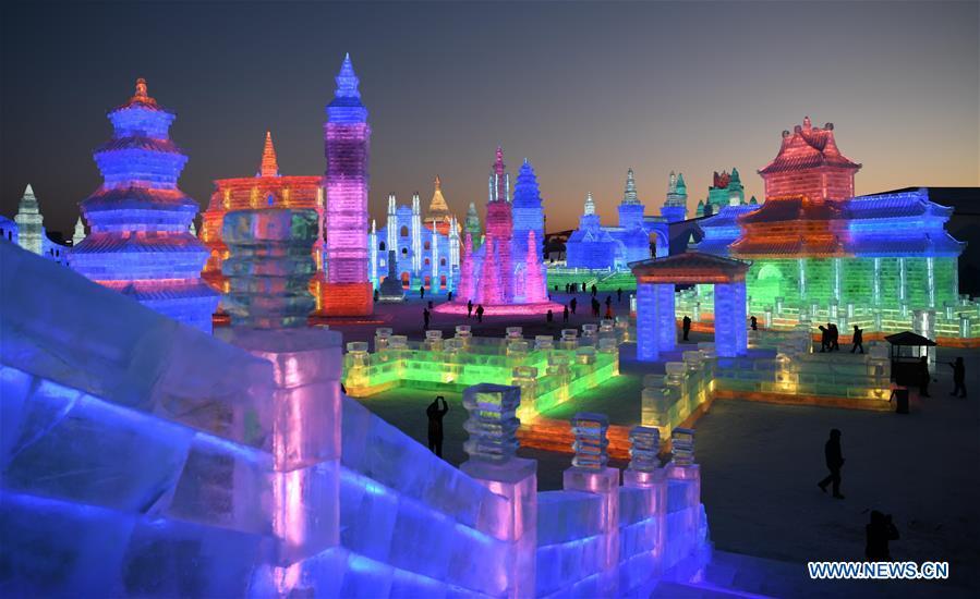 Tourists visit the Ice-Snow World in Harbin, capital of northeast China\'s Heilongjiang Province, Dec. 23, 2018. The Ice-Snow World opened on Sunday in Harbin. Covering an area of 600,000 square meters, the park used 110,000 cubic meters of ice and 120,000 cubic meters of snow this year. (Xinhua/Wang Jianwei)